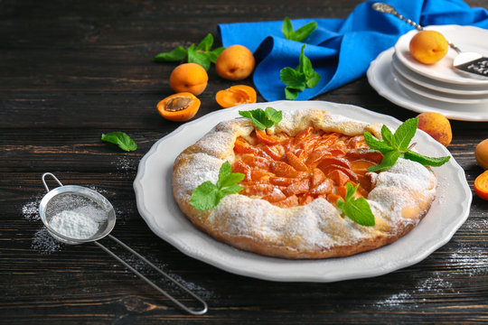 Delicious apricot cake on table