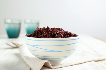 Bowl with red rice on table