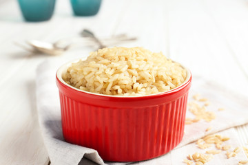 Bowl with brown rice on table