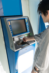 Asian woman looking at monitor screen