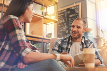 Cheerful startuppers meeting cafe for project discussion