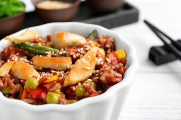 Bowl with brown rice and vegetables, close up
