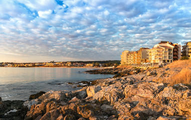 View of the hotels of the new part of the Sozopol resort, the rocky shore and the city beach in the morning.