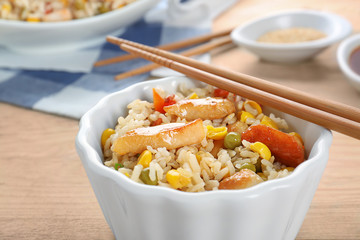 Bowl with tasty brown rice and vegetables, close up