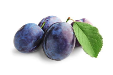 Ripe plums on white background