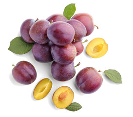 Fresh ripe plums on white background