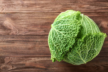 Green cabbage on wooden background