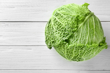 Green cabbage on wooden background © Africa Studio