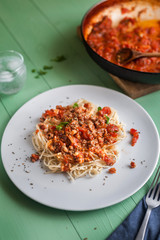Plate of freshly prepared spaghetti bolognaise with a tomato sauce and basil ready to be served