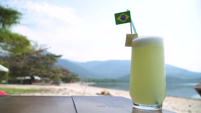 Ice cold lime lemonade with Brazilian flag at the beach