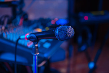 Microphone on stage. Microphone close-up. A pub. Bar. A restaurant. Music. Evening. Night show.