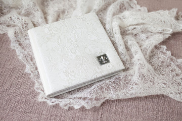 Photo book with a cover of genuine leather. White color with decorative stamping . Soft focus.