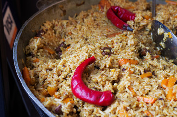 Preparation of pilaf with chili pepper.
