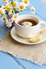 cup of herbal chamomile tea with camomile dry blossoms, dried camomile flowers. doctor treatment and prevention of immune concept, medicine - folk, alternative, complementary, traditional medicine 