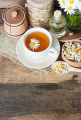 cup of herbal chamomile tea with camomile dry blossoms, dried camomile flowers. doctor treatment and prevention of immune concept, medicine - folk, alternative, complementary, traditional medicine 