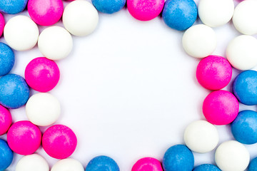 Colored chocolate coated candy on wooden background