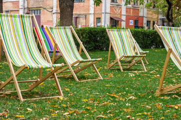 Beach chairs in a row. A place to relax. Autumn rest on the armchair.