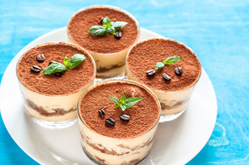 luxurious dessert Tiramisu in a glass with coffee beans on a dark background