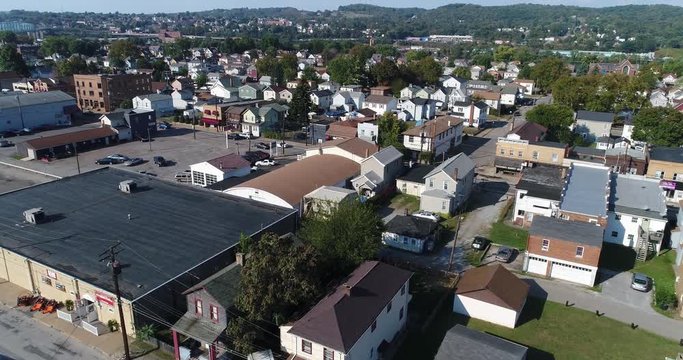 A daytime aerial establishing shot of a typical Pennsylvania small town neighborhood district.  	