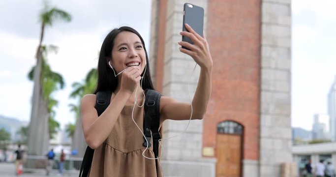Woman travel in Hong Kong and talking on video call with cellphone in Hong Kong