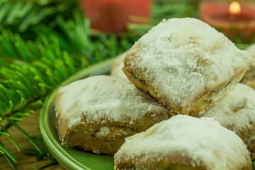 Christmas decoration - pine branch with red candles and Christmas biscuits