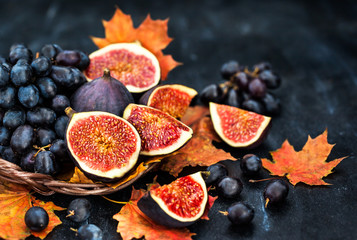 Autumnal fresh ripe figs and purple grape