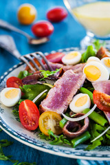 Tuna salad with tomatoes, boiled eggs, onion, anchovy and lettuce