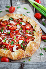 Delicious homemade rustic open pie (galette) with tomato, cheese and onion