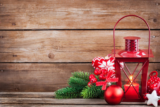 Christmas time red latern with candle light and holiday decorations around