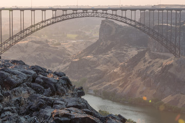 Rocky Cliff Looks Out Over The Perrine Bridge at Sunset