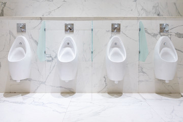 Row of urinals men public toilet, Closeup white urinals in men's bathroom, design of white ceramic...
