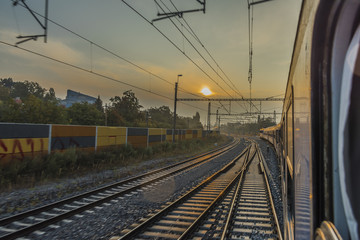 Fototapeta premium Fast train from Prague to south of Bohemia with sunrise