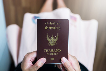 Hand holding Thailand two passport