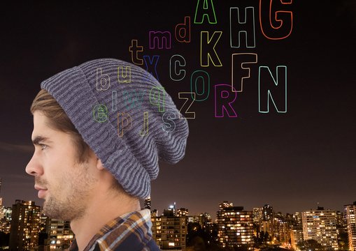hipster in front ogf the city at night, thinking. colour letter