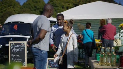  Cheerful father & daughter shopping for fresh produce at the farmers market. 