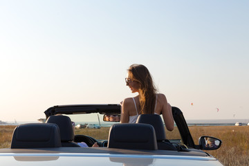 Two attractive young women in a cabriolet car