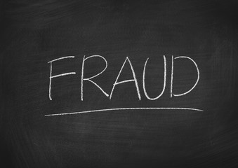 Obraz premium fraud concept word on a blackboard background