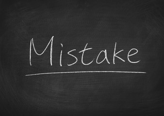 Obraz premium mistake concept word on a blackboard background