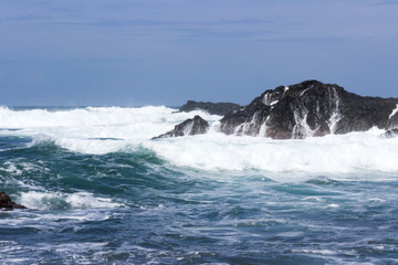Waves crash onto volcanic rocks.  The Pacific Ocean at Playa San Juanillo, Costa Rica.