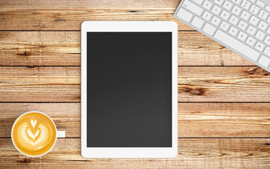 Modern workspace with coffee cup tablet or smartphone and keyboard copy space on wood background. Top view. Flat lay style.