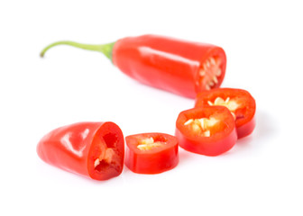 Closeup top view red chili pepper with sliced on white background, raw food ingredient concept, selective focus