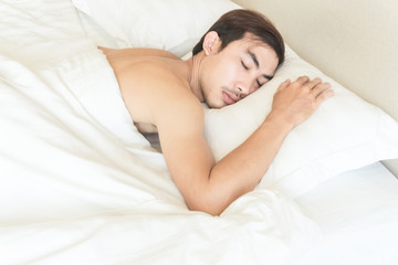 Obraz na płótnie Canvas Closeup man sleeping on bed, health care and medical concept, selective focus