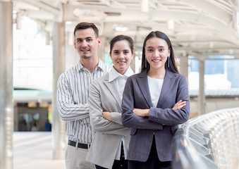 Group of young caucasian business people in the city with successful and confident feeling