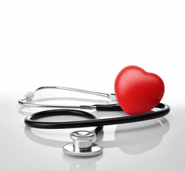 Stethoscope with red heart on white background.