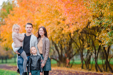 Fototapeta premium Portrait of happy family of four in autumn day