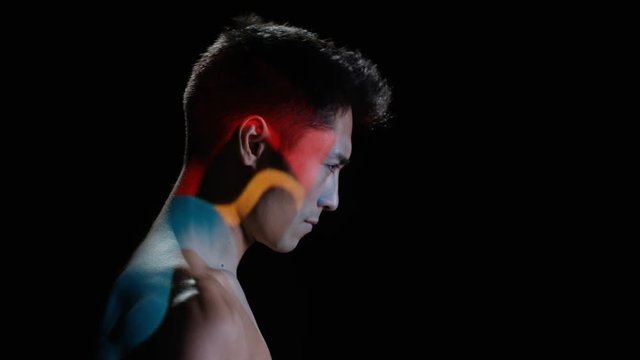  Colorful patterns of light projected onto the face & body of attractive model