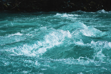 Crystal clear glacial water of the river of turquoise color