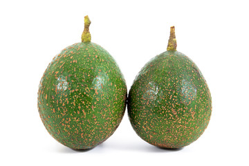 It is two raw avocado isolated on white background