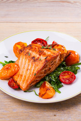 Salmon fillet with spinach, tomatoes and herbs, vertical