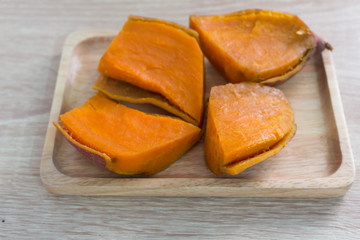 Fototapeta na wymiar Sweet potato on the wooden table